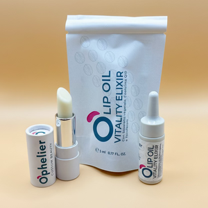 Lip oil vitality elixir set with vegan lip balm, dropper bottle and pouch on beige background