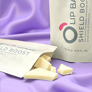 Natural lip balm bar pieces on a soft purple fabric, eco-friendly cosmetics packaging
