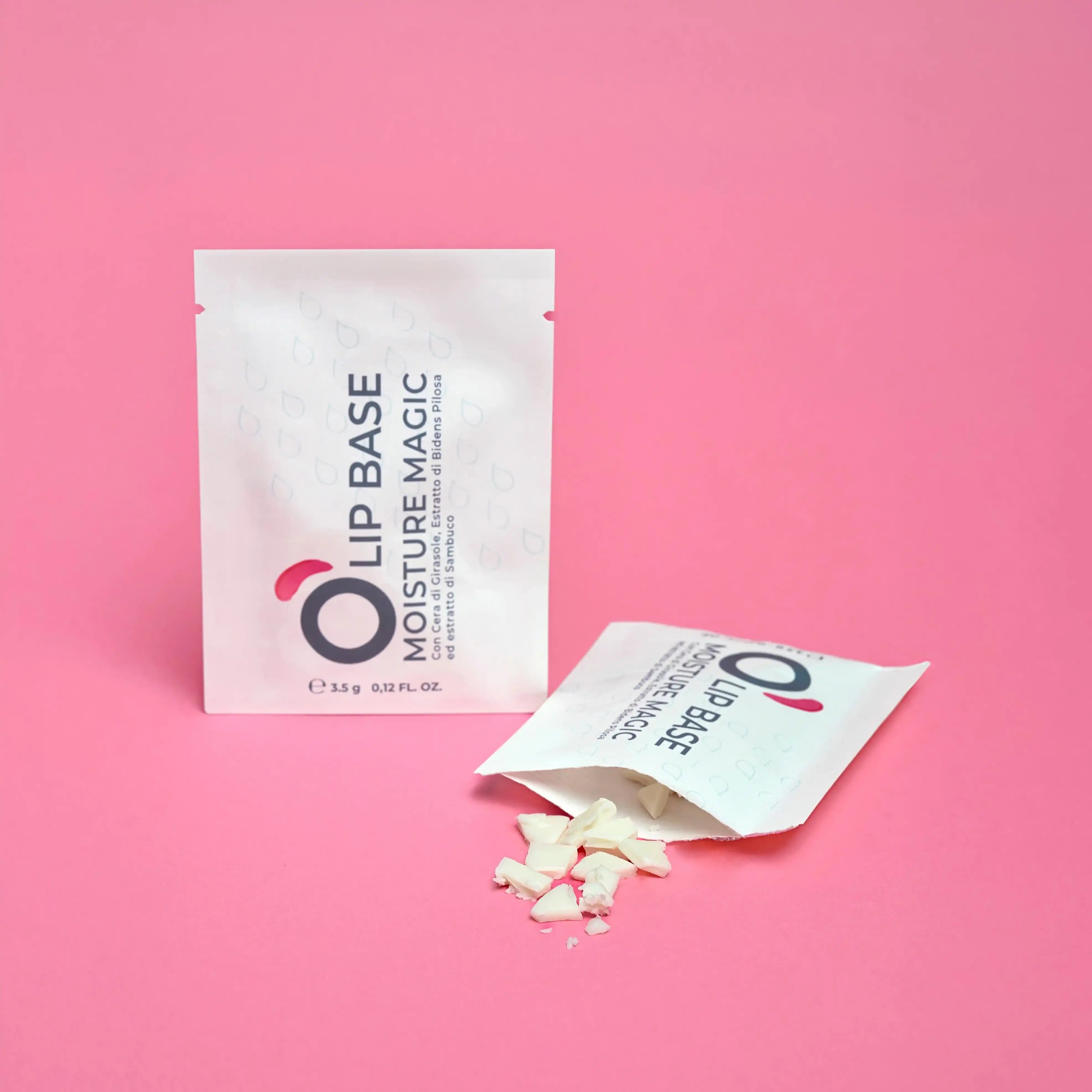 Lip base moisture magic sachets with product pieces on pink background