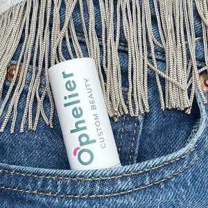 Ophelier custom beauty cosmetic tube in denim pocket with decorative fringe