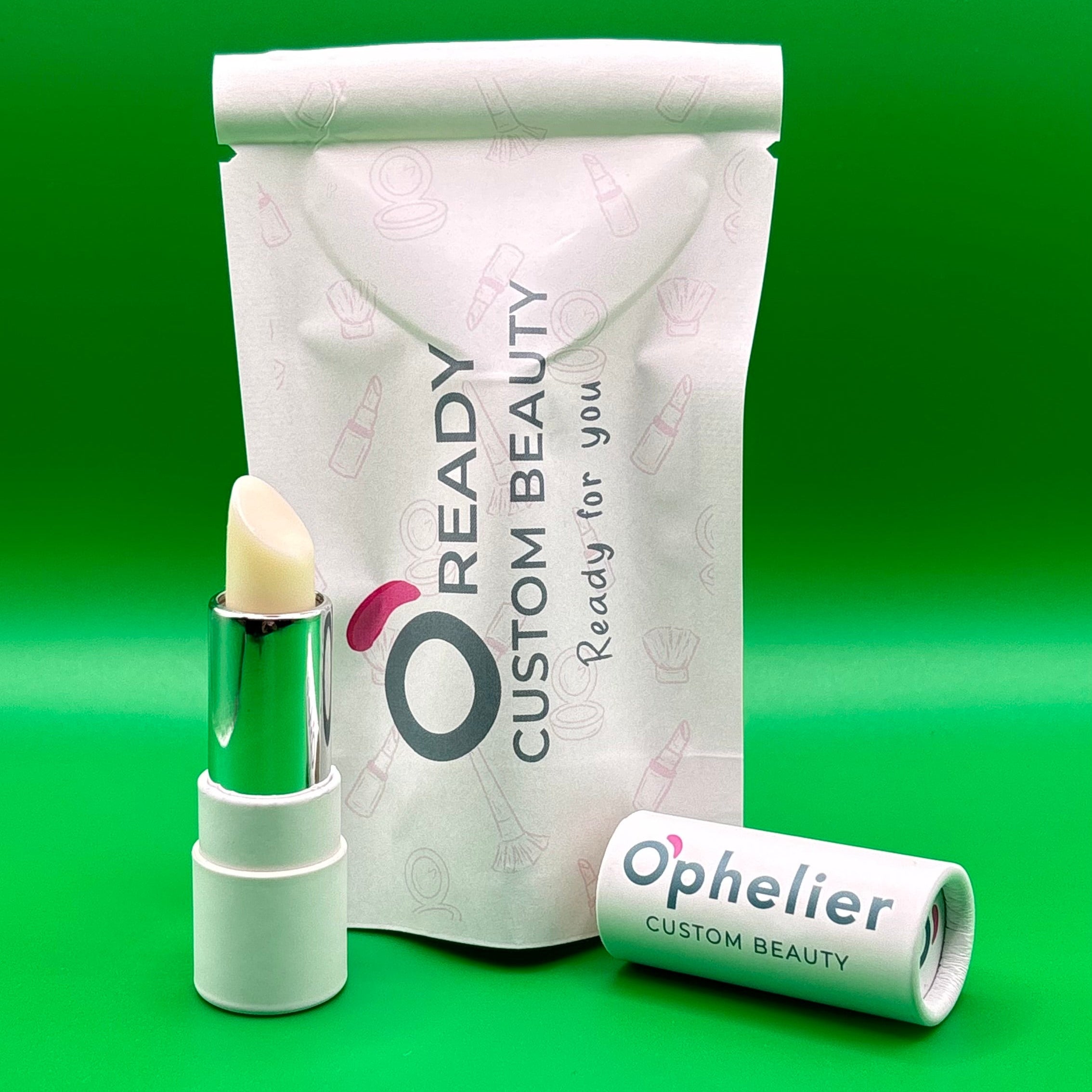 Natural vegan lipstick in white tube with custom beauty packaging on green background