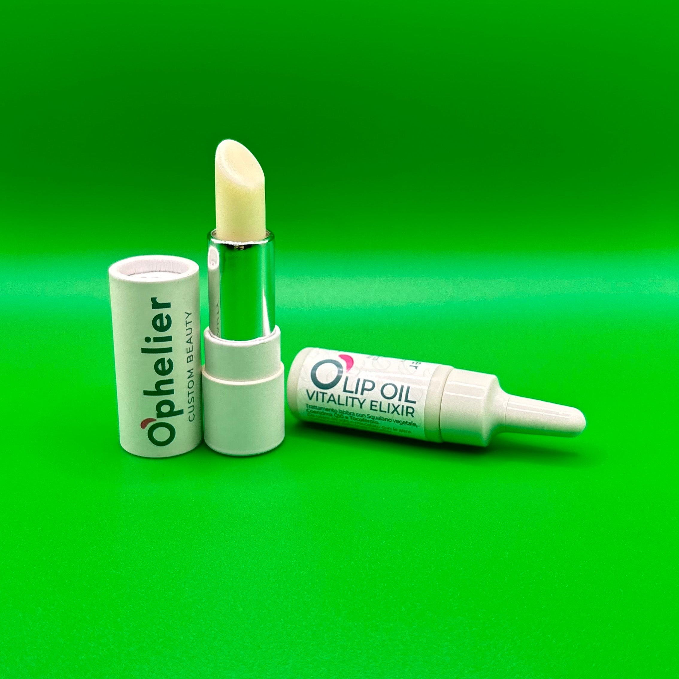 Natural lip balm and lip oil vitality elixir on green background, vegan beauty products