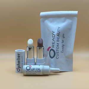 Custom beauty set with two lip balms, lip oil, and branded pouch on beige background