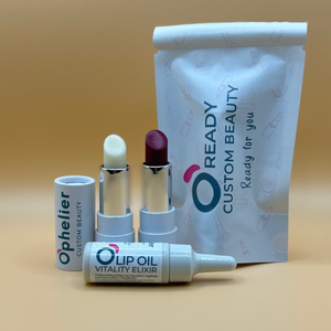 Custom beauty set with clear and berry lip balms, lip oil, and branded packaging.