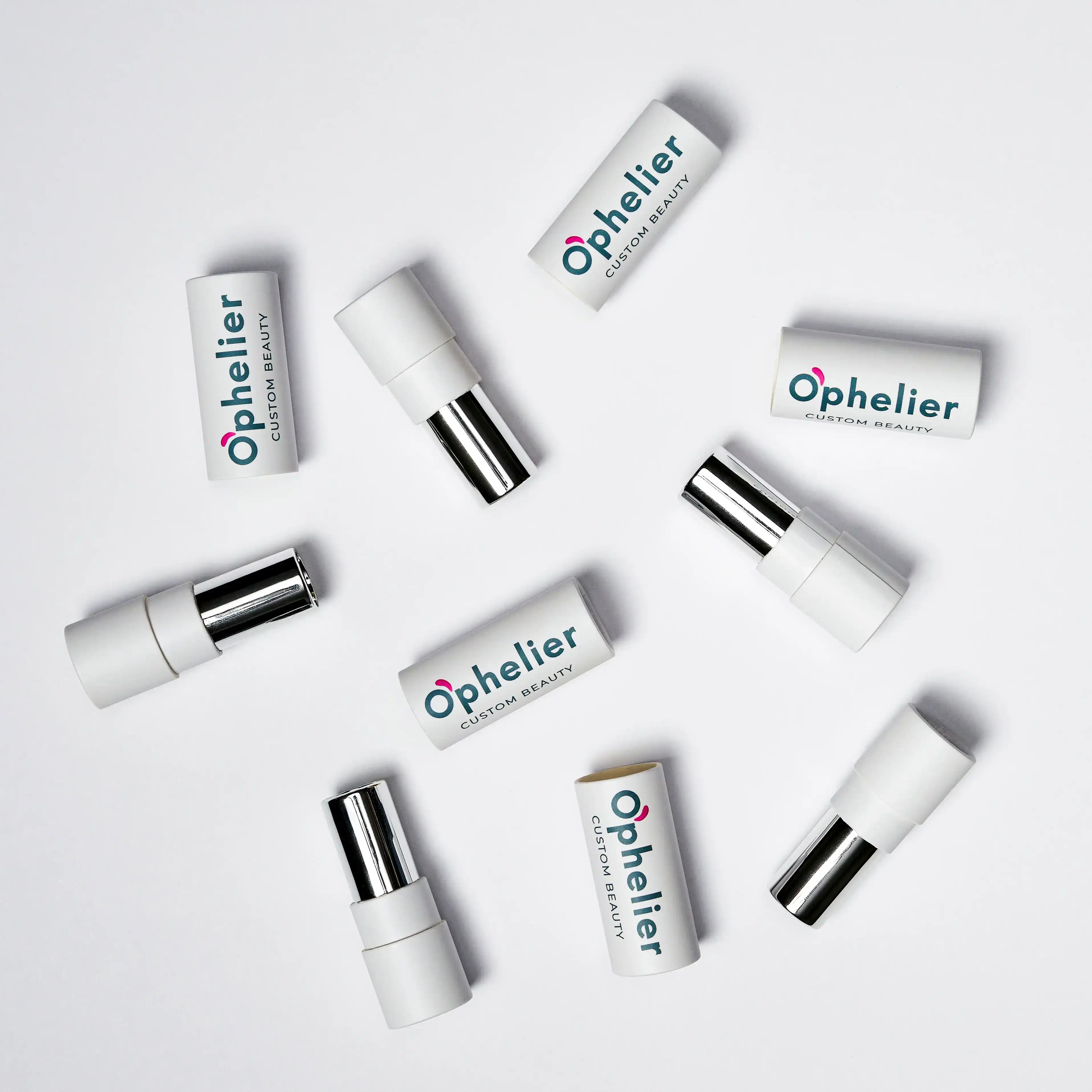 Assorted white lipstick tubes with chrome accents arranged on a white background.