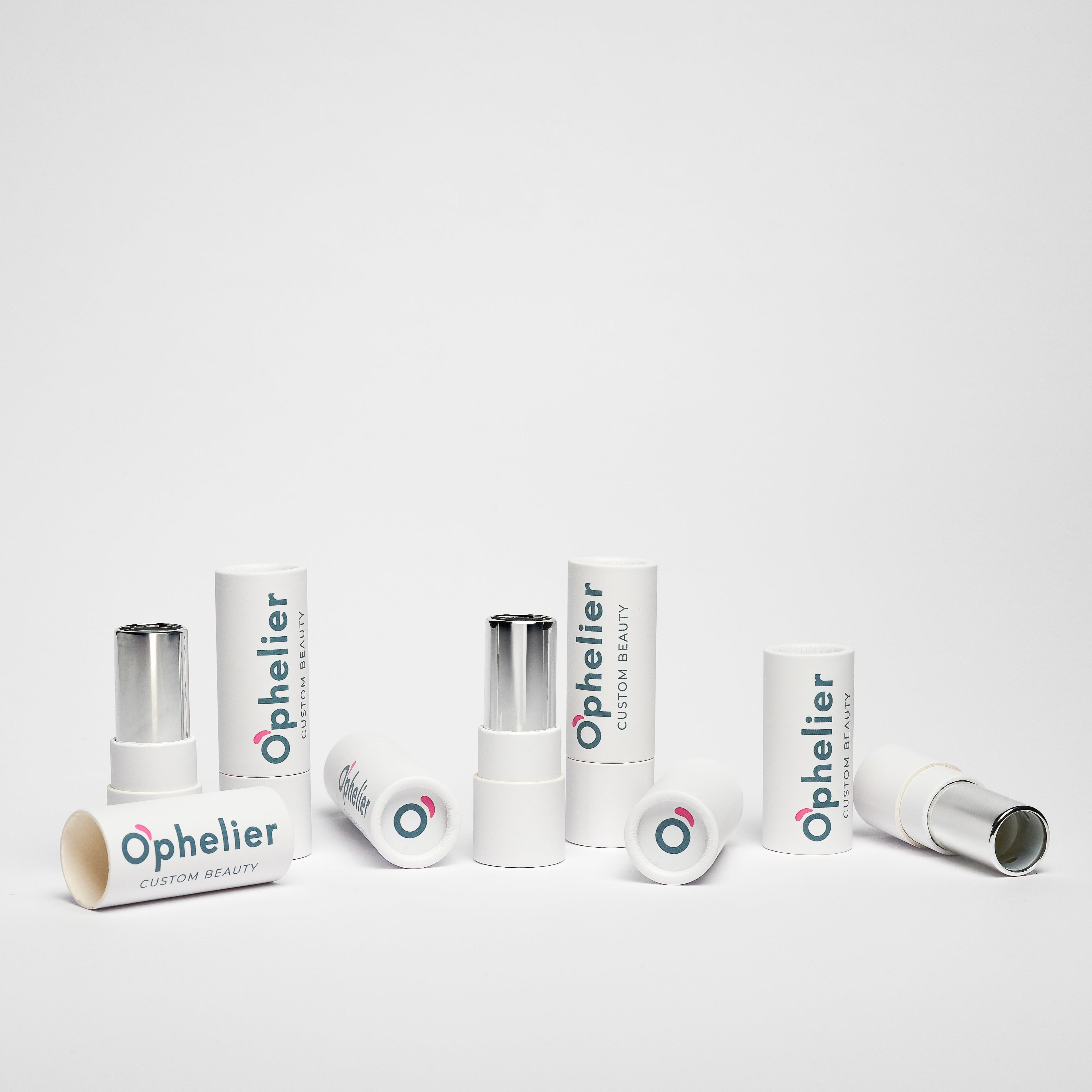 Assorted white makeup lipstick tubes arranged on a clean white background
