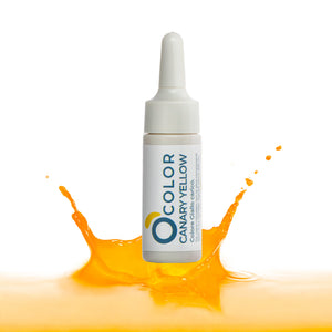 Canary yellow cosmetic pigment bottle with yellow liquid splash on white background