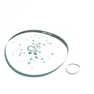 Clear gel serum drop with air bubbles on white background, natural skincare product texture