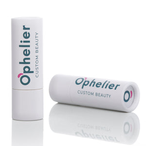 White tube lip balm with custom beauty label on reflective surface