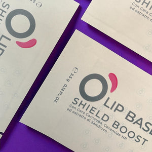 Natural vegan lip balm packaging on a purple background, labeled shield boost formula.