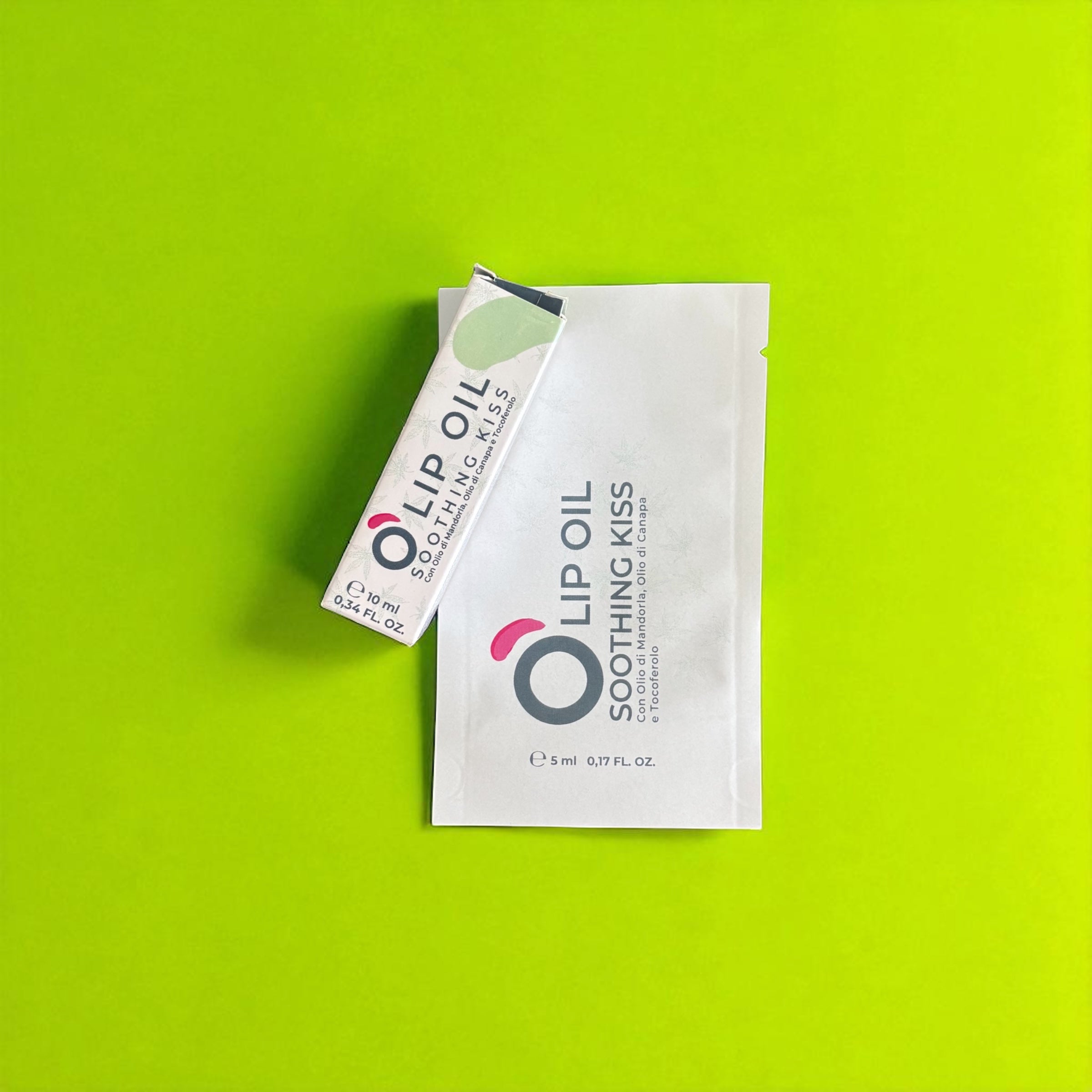 Lip oil Soothing Kiss packaging on bright green background, vegan natural beauty product