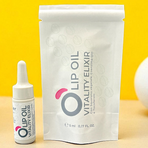 Lip Oil Vitality Elixir vegan natural beauty product in dropper bottle and pouch on yellow background