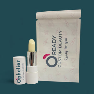 Natural vegan lip balm stick with white case and custom beauty packaging on teal background